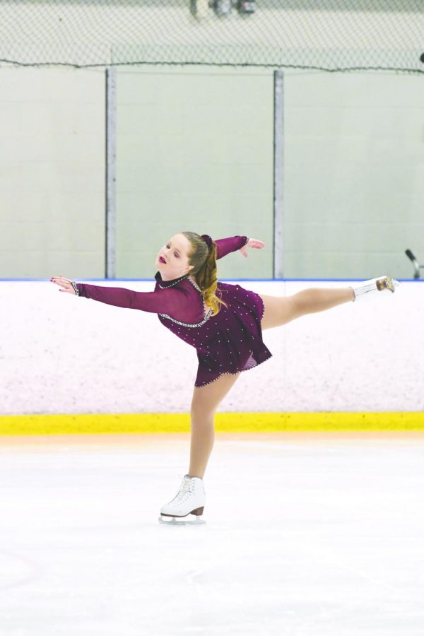 Sophomore Sarah Bunker performs a right forward outside edge spiral on the ice at a solo skating competition.