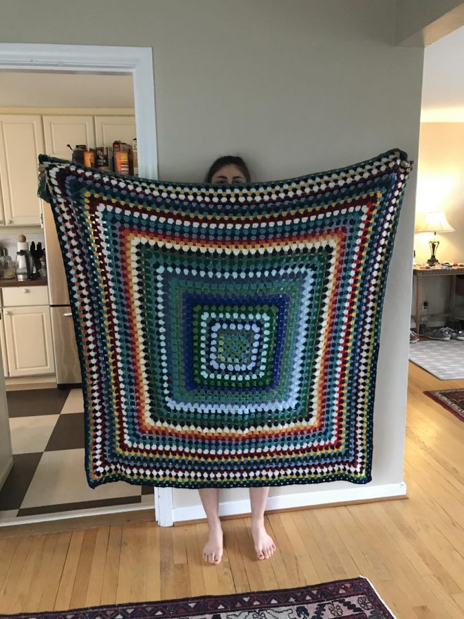 Olivia Poolos shows her crocheted blanket.