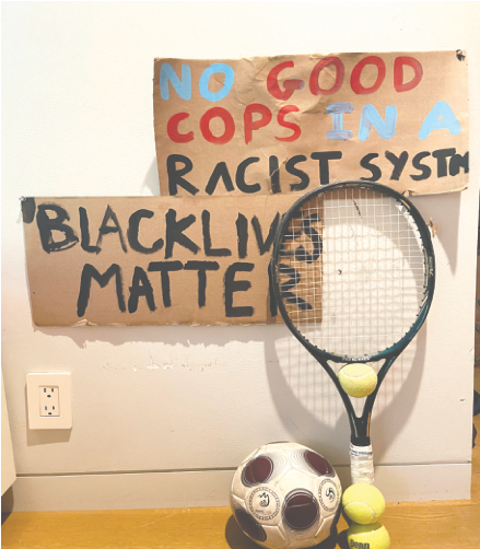 Sports Equipment in front of a “Black Lives Matter” Poster. Professional athletes have played a big role in ongoing racial justice protests.