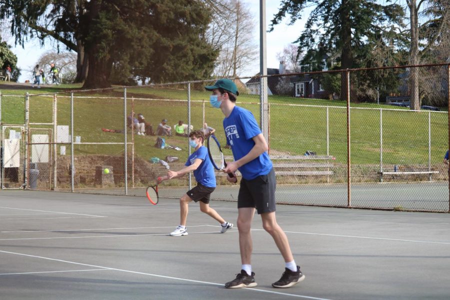 Boys’ Varisty tennis duo Eli Pruzan and Carter Cast play South Whidbey
in front of supporters on March 18, 2021.