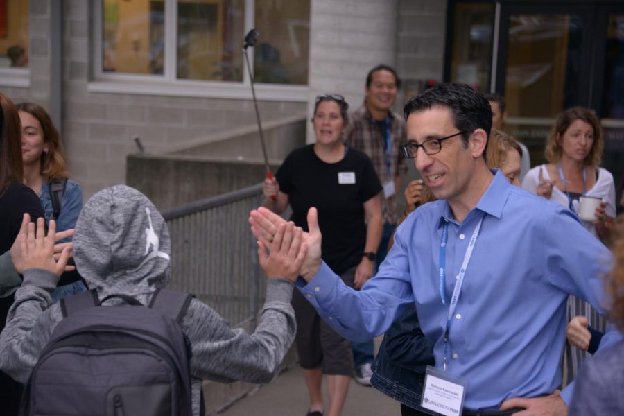 Richard Kassissieh high-fives a student on the first day of school in 2019.