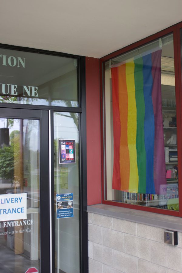 A pride flag hangs in the window at the entrance to UPrep