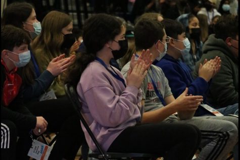 Students clapping after a keynote speaker finishes.