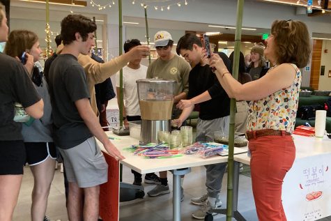 Director of Marketing & Communications Mary Beth Lambert takes pictures of students waiting in line to receive bubble tea.