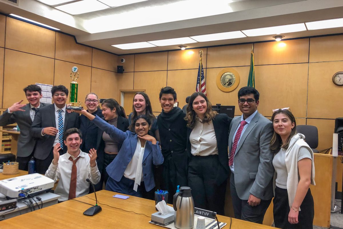 The varsity mock trial team and supporters celebrate after placing second in districts at the Pierce County courtroom. 