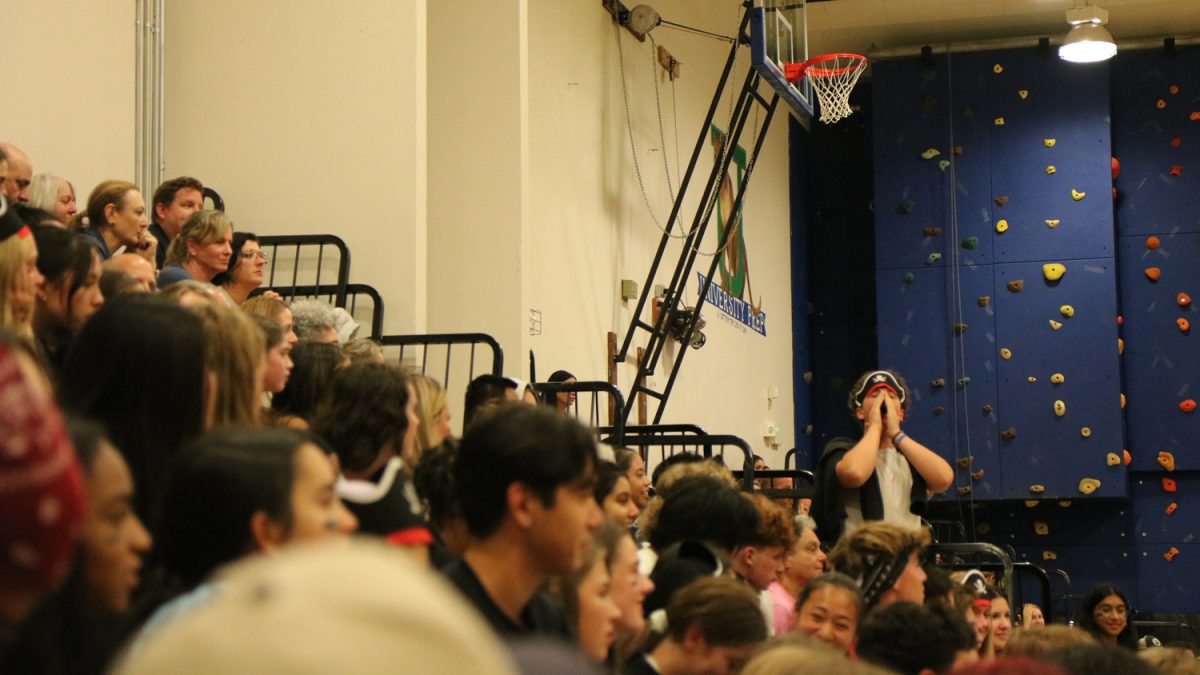 Ninth grader Mikael Harmelin leads a chant during UPrep's Homecoming Volleyball Game