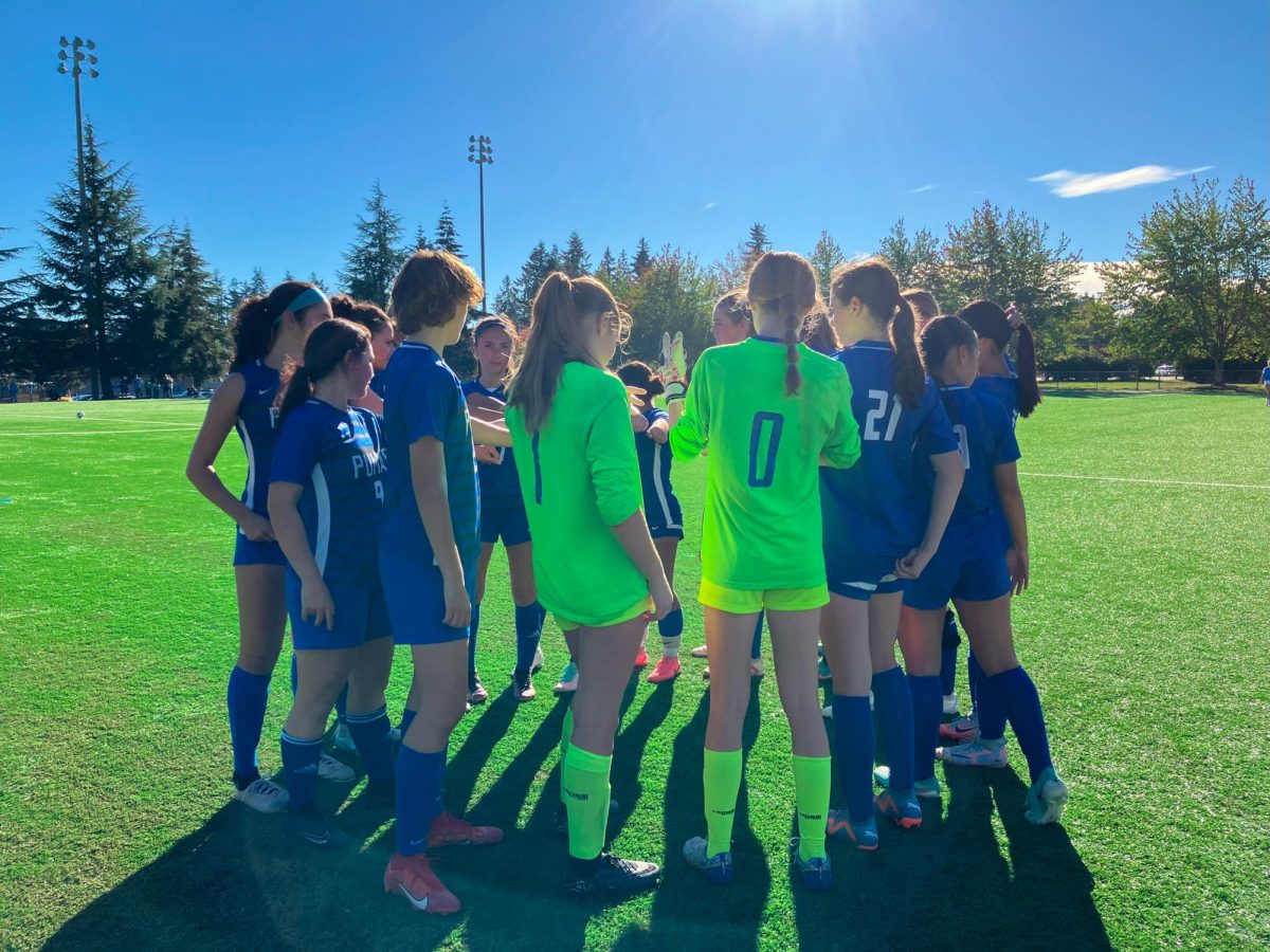 Varsity Girls Soccer team huddle 