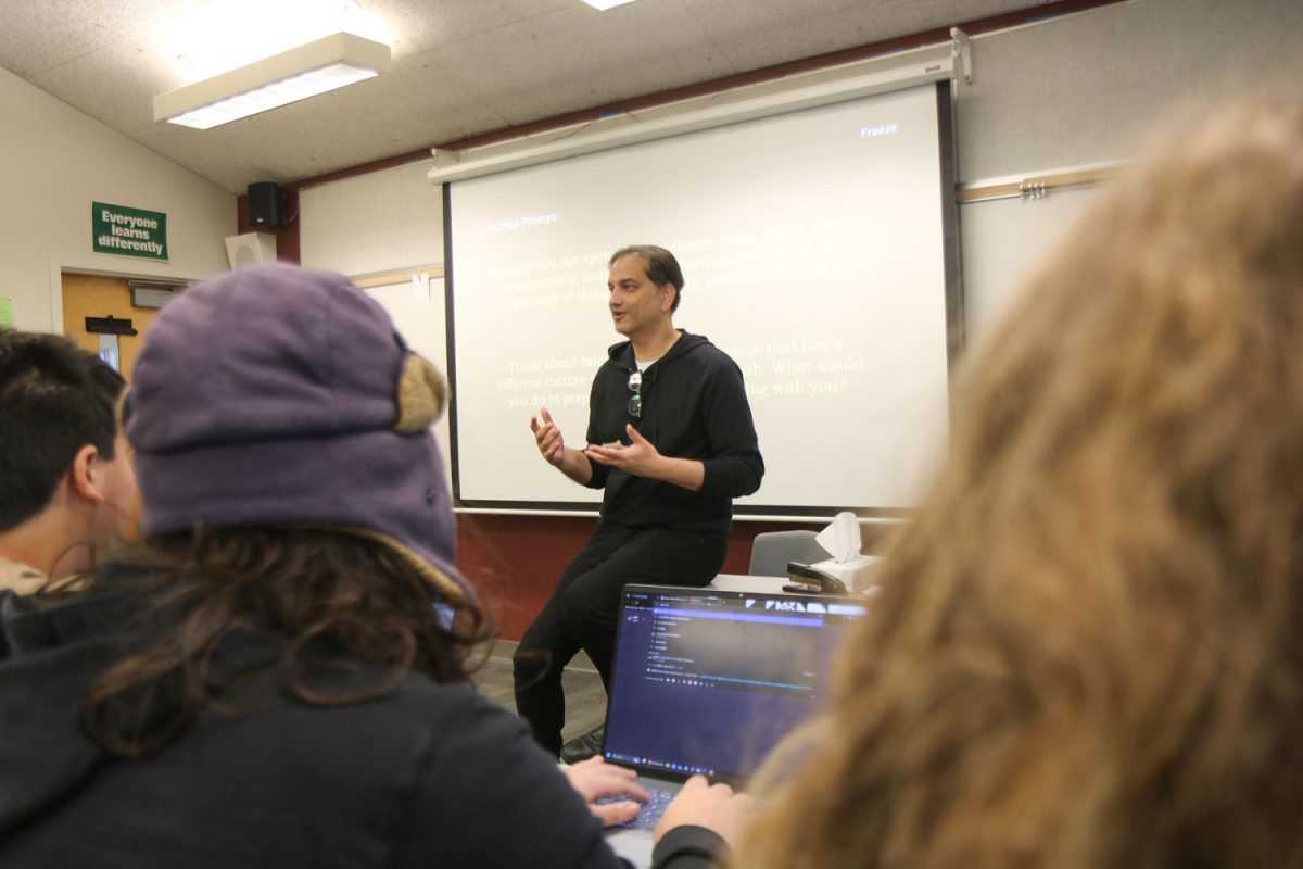 Raj Bhat sits in front of his class as he gives a lecture. 