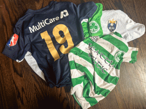 Soccer jerseys piled on player’s floor.