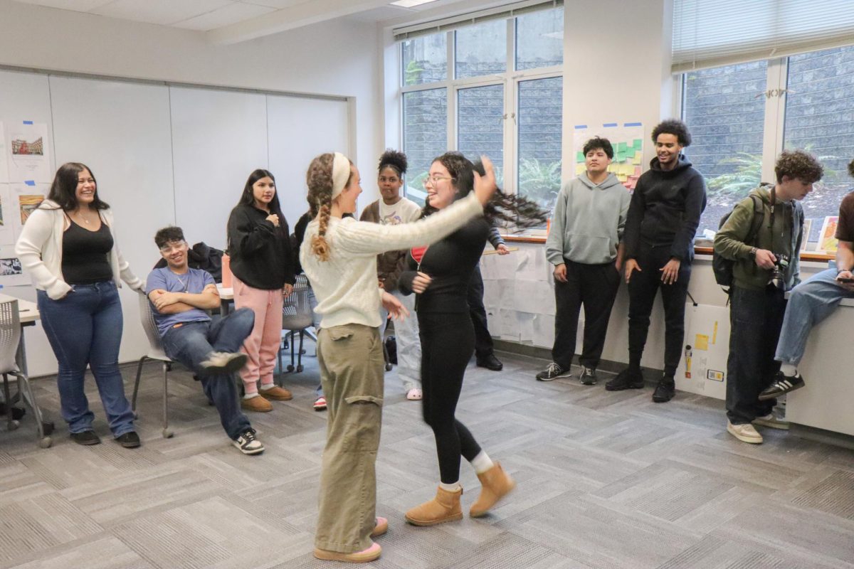 Students practice dances in a Latinx Student Union (LSU) meeting.