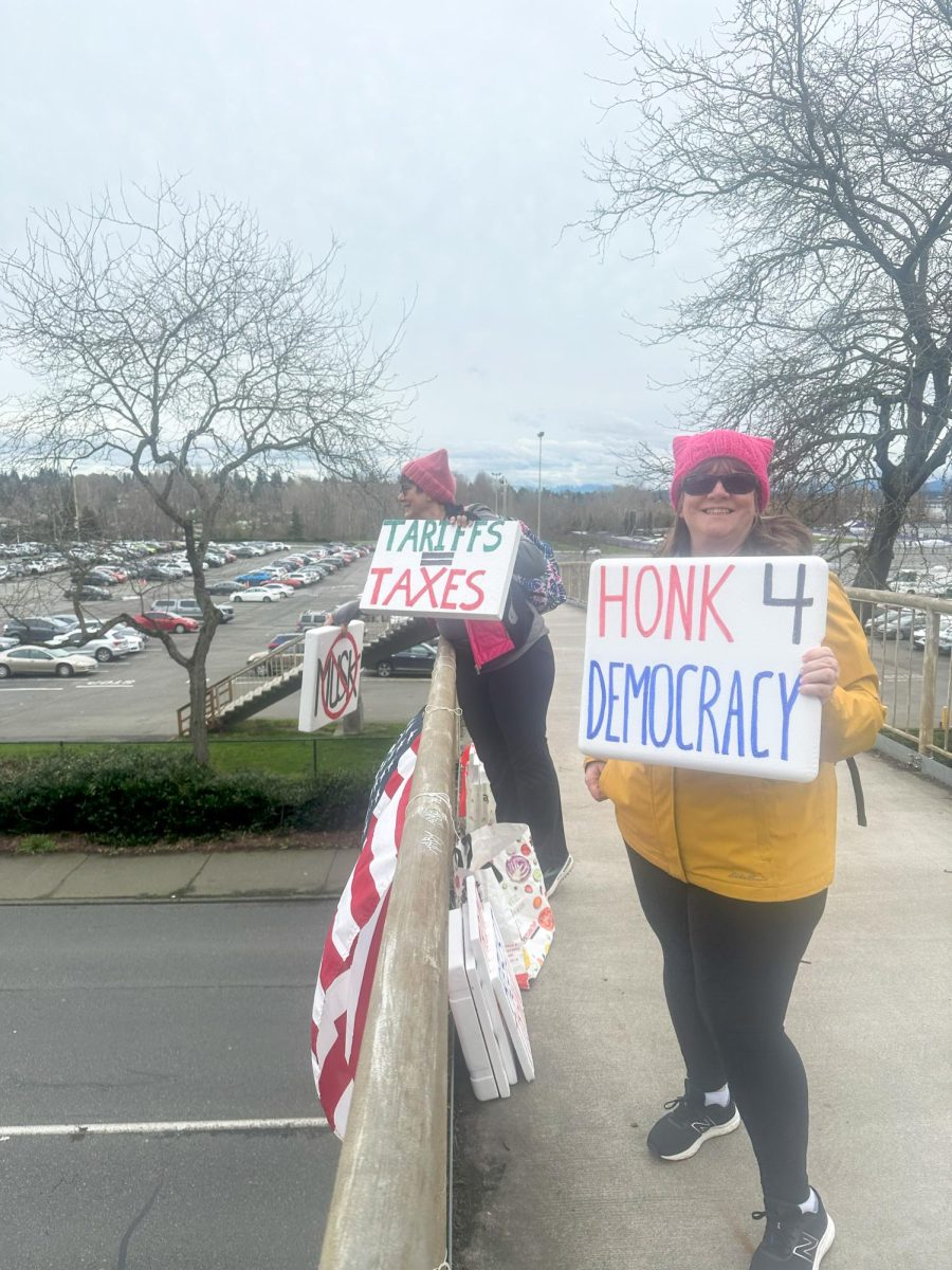 Robin Perez and Dawn Lum protest Monday through
Friday on a bridge above Montlake Boulevard near the
University of Washington. 