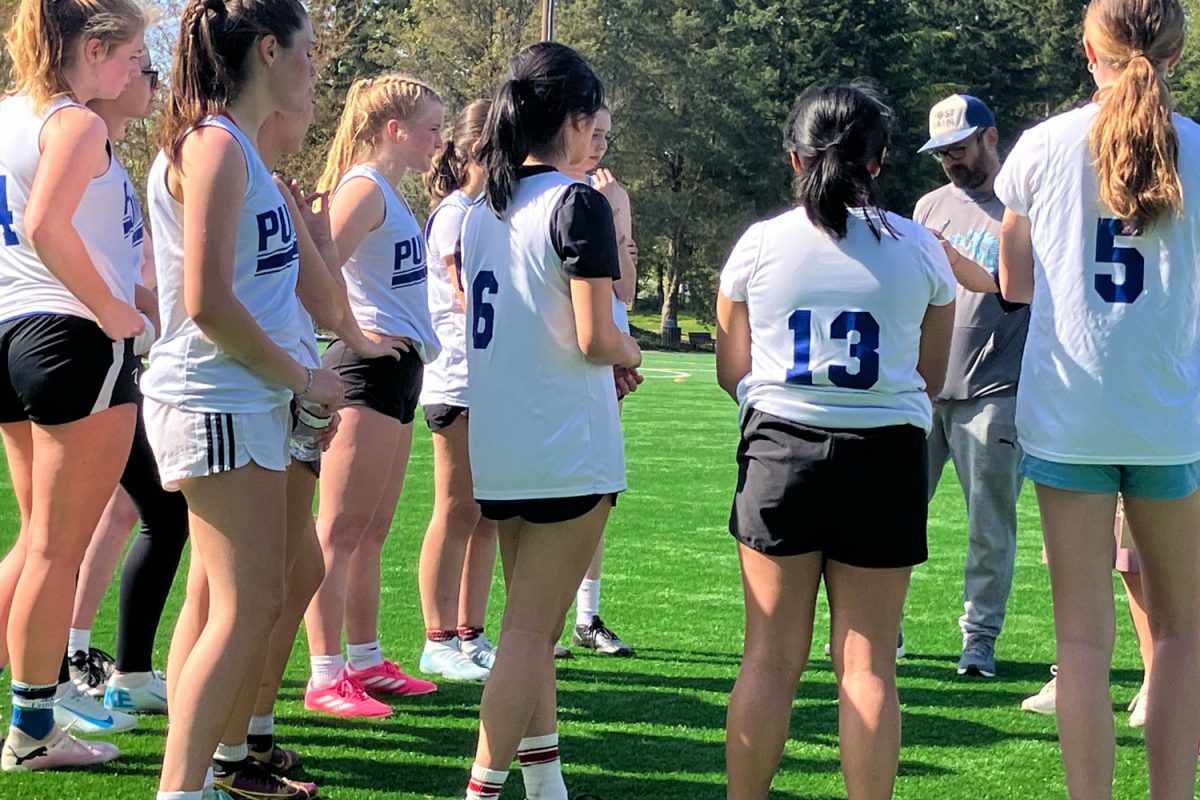 The girls varsity ultimate team huddles up during a timeout.