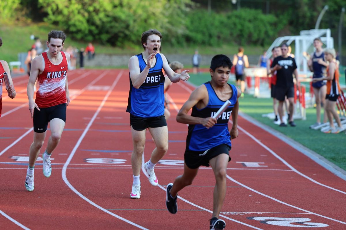 Boys 4x400m relay, sophomore Steven Ratsch hands the baton to sophomore Benjamin Gamez.