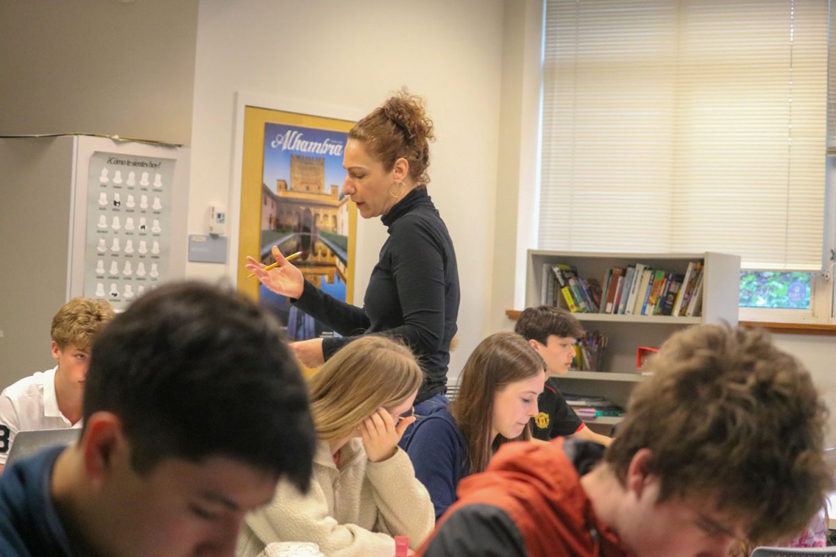 Spanish Teacher Aviva Kana instructs her class of upper schoolers on the conventions of Spanish grammar.