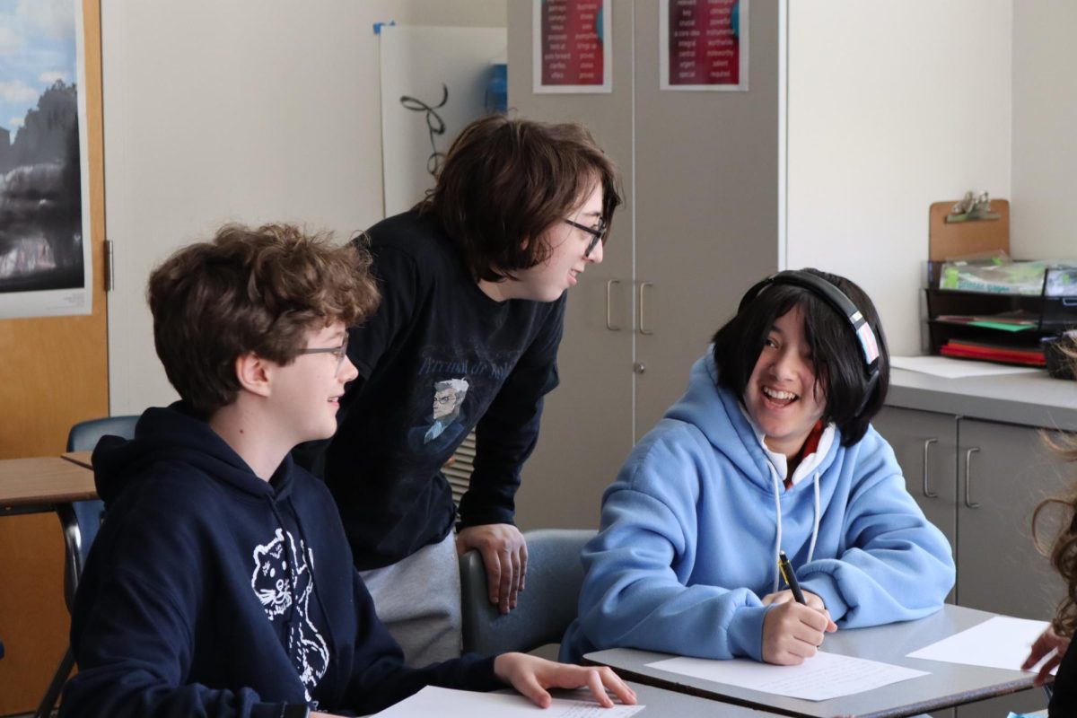 Streat works with students to prepare for a debate during practice.
