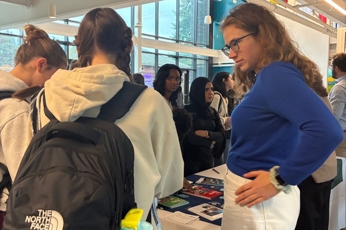 A UPrep students talks with an SYA representative at the semester away presentation.