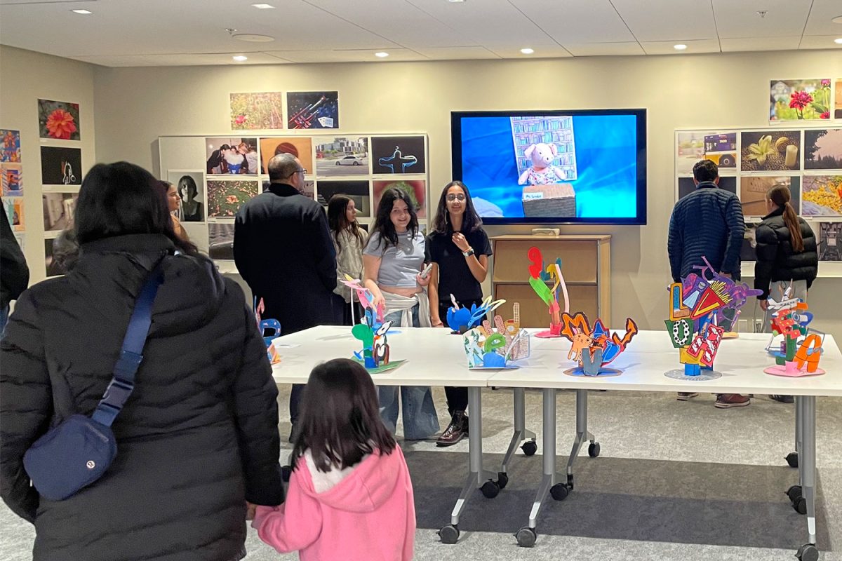Students and parents admire the artwork at the Visual Arts Showcase