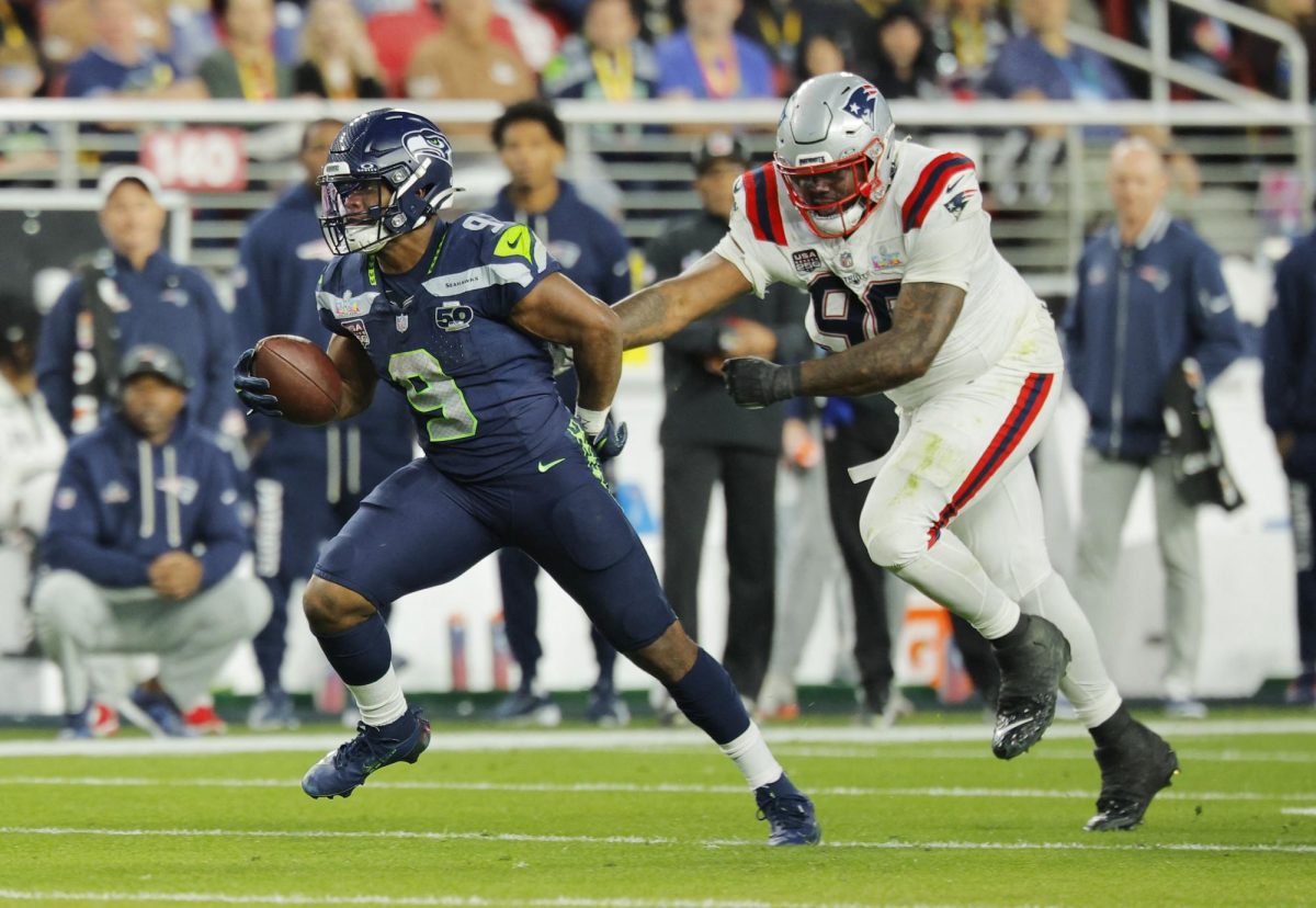 Football - NFL - Super Bowl LX - New England Patriots v Seattle Seahawks - Levi's Stadium, Santa Clara, California, United States - February 8, 2026 Seattle Seahawks' Kenneth Walker III in action with New England Patriots' Christian Barmore REUTERS/Mike Blake
