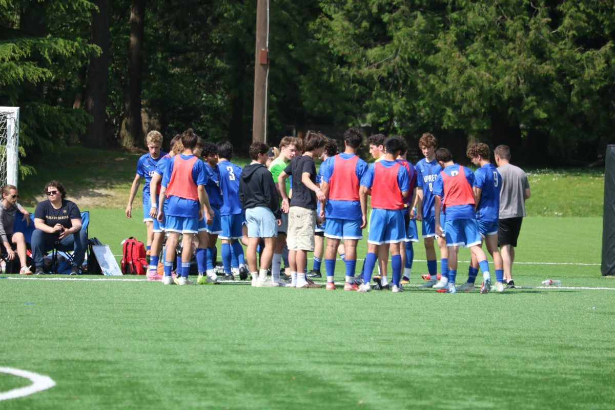 UPrep boys soccer team huddles at halftime.