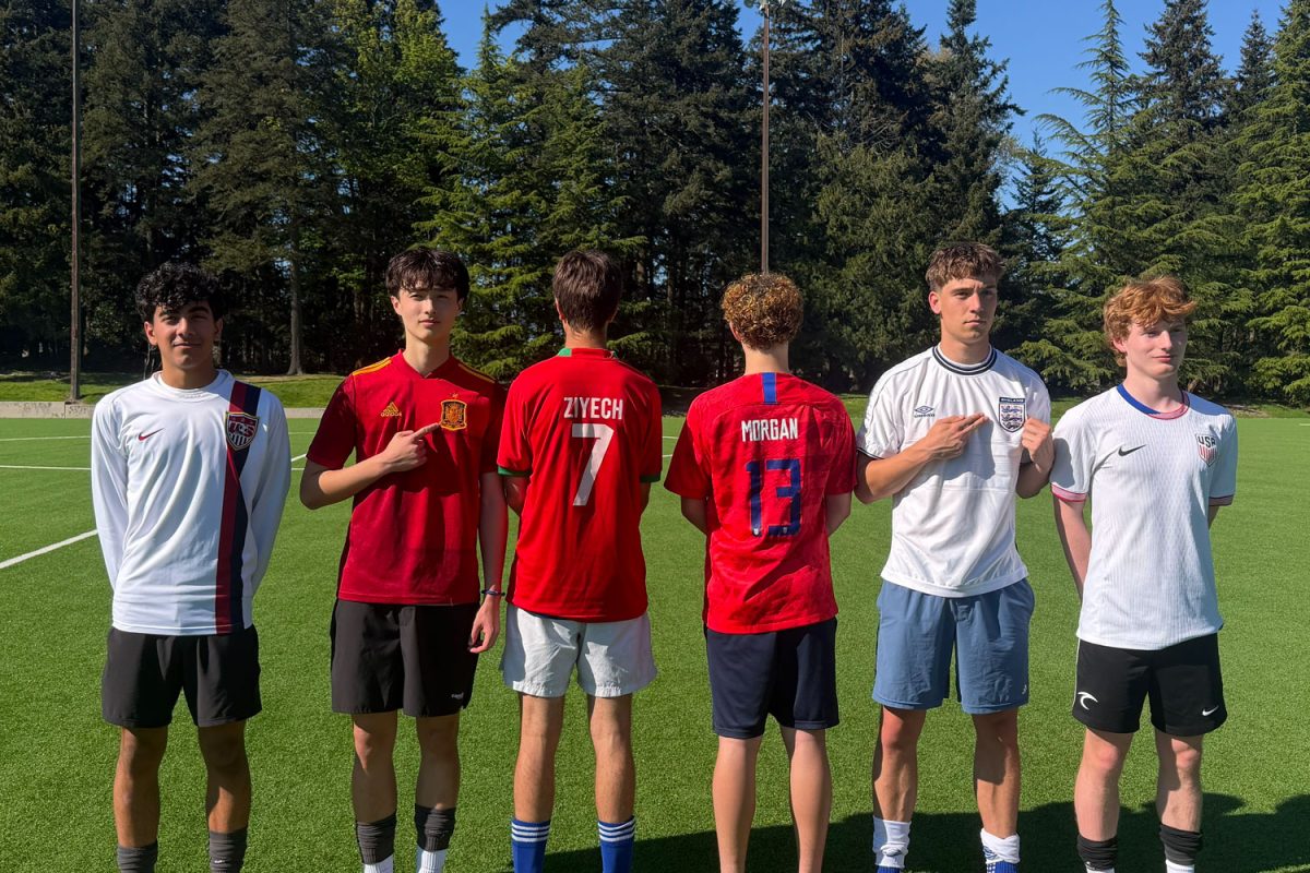 UPrep varsity soccer players [left to right] Rayhan Irani, Jack Hyde, Tom Tooth, Dylan Marin-Crowley, Rowan Sim and Preston Guy pose in national team jerseys.
